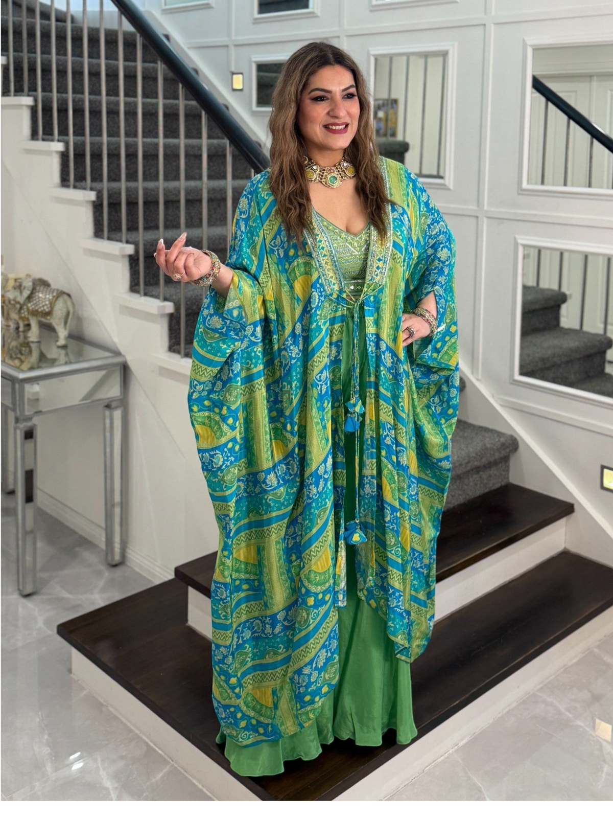 PanacheByDivya indo-western outfit featuring a blue and green patterned kaftan cape over a matching green dress