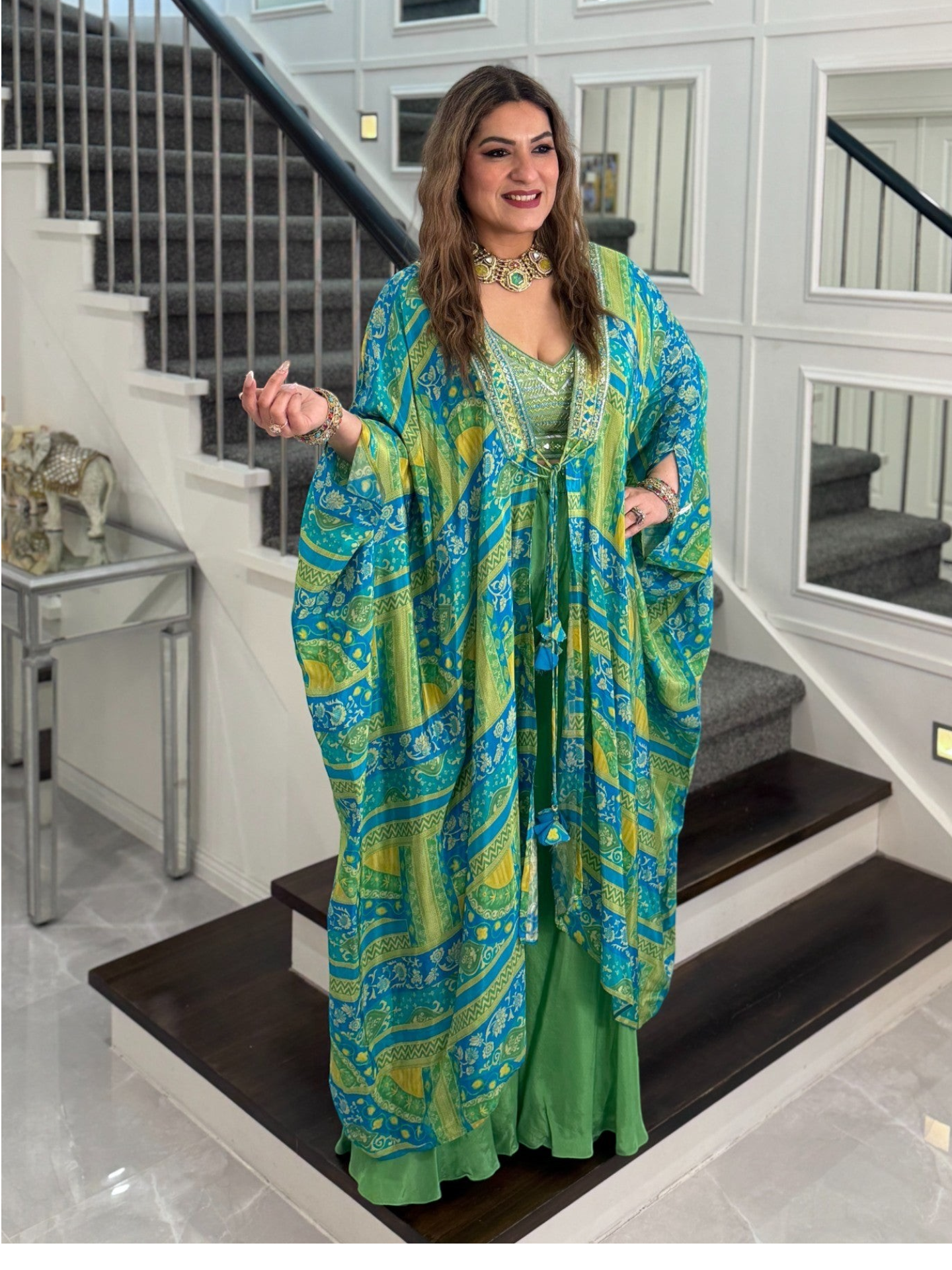 PanacheByDivya indo-western outfit featuring a blue and green patterned kaftan cape over a matching green dress