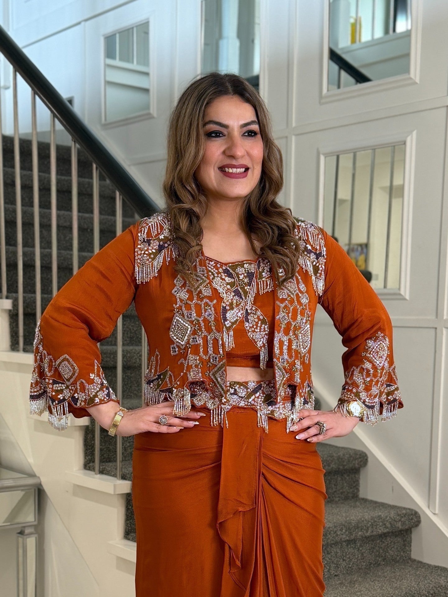 PanacheByDivya rust orange indo-western outfit featuring an embroidered cropped jacket with beaded fringe details.